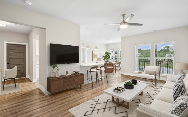 open-concept living room with ceiling fan and large windows