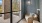 glass door in patio with a chair, table and rug