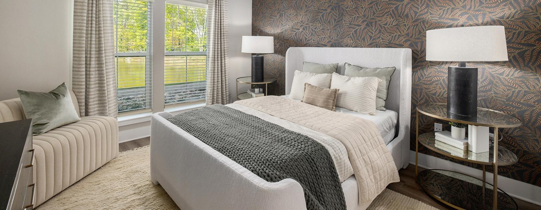spacious bedroom with ceiling fan and light